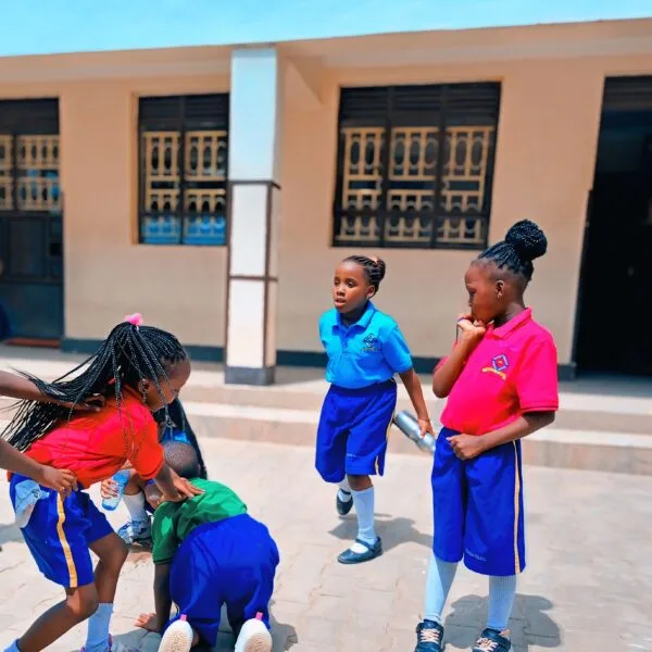 kasumba-nursery-and-primary-school-learners-playing-skip-rope-on-school-compound-mubende-uganda-scaled