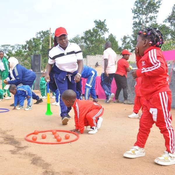 Kasumba pupils playing together on the playground at Kasumba Nursery and Primary School in Mubende