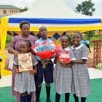 Parent sharing a testimony about education at Kasumba Nursery and Primary School