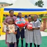 Parent sharing a testimony about education at Kasumba Nursery and Primary School