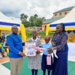 Parent sharing a testimony about education at Kasumba Nursery and Primary School