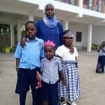 Parent sharing a testimony about education at Kasumba Nursery and Primary School