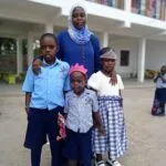 Parent sharing a testimony about education at Kasumba Nursery and Primary School